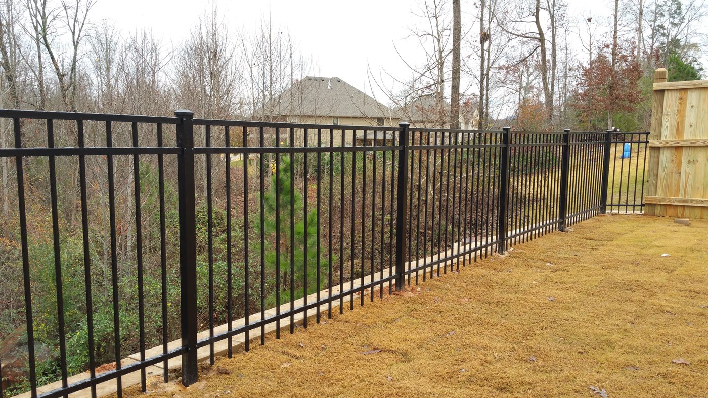 Black aluminum three-rail flat-top fence bordering a residential yard, installed by FenceWorks of Georgia