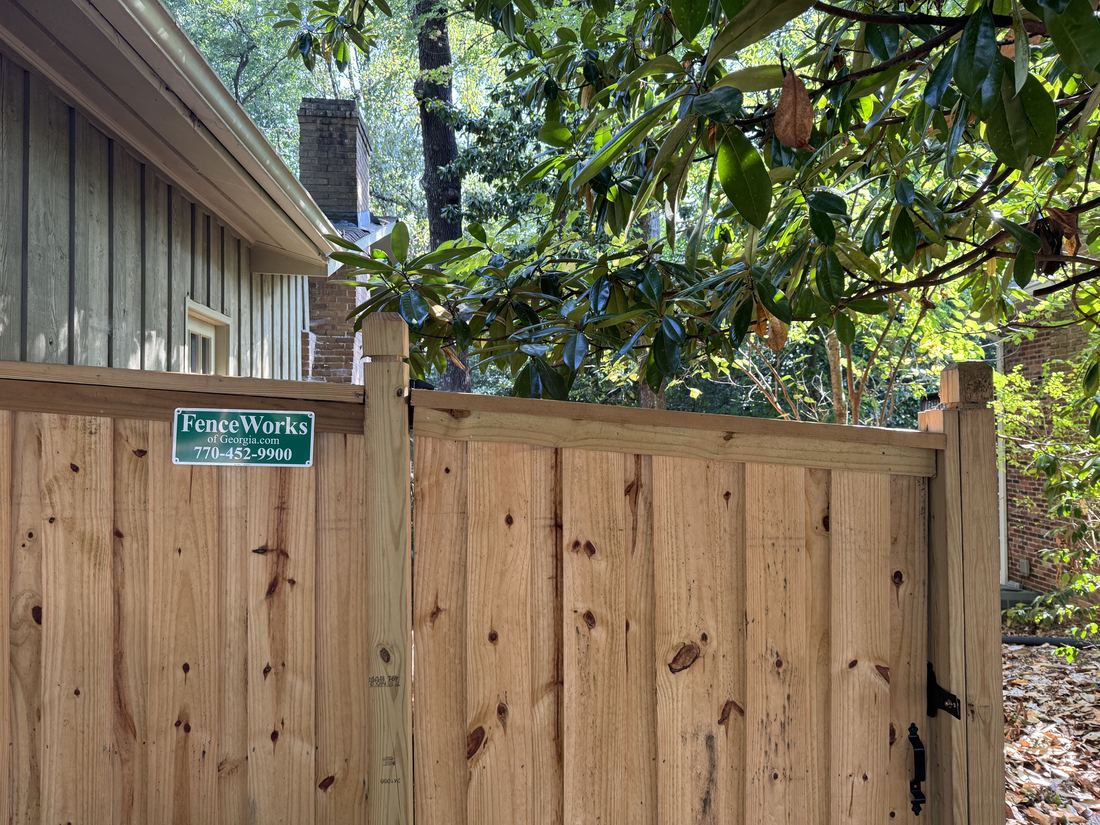 Board on board capped wood privacy fence with dado posts