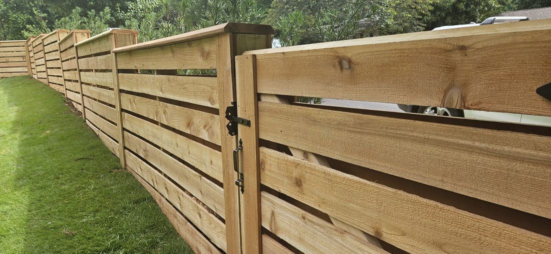 Cedar horizontal wood fence stair stepped with beveled cap
