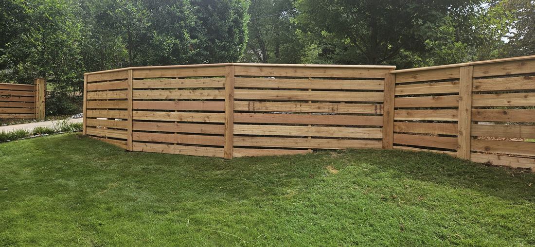 Cedar horizontal wood fence stair stepped with beveled cap