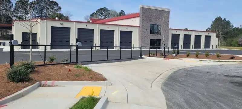 Commercial cantilever slide gate with steel fences at a business entrance