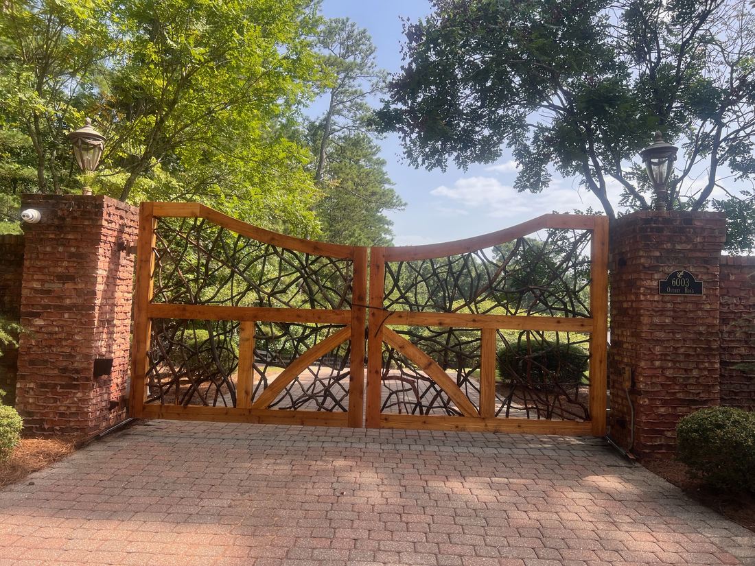Custom driftwood-stained wood driveway gate, built by FenceWorks of Georgia