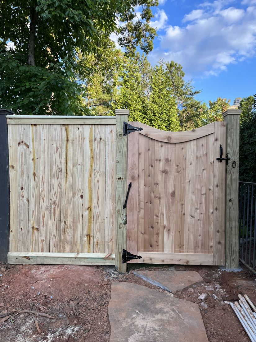 Custom wood walk gate matched to the surrounding privacy fence