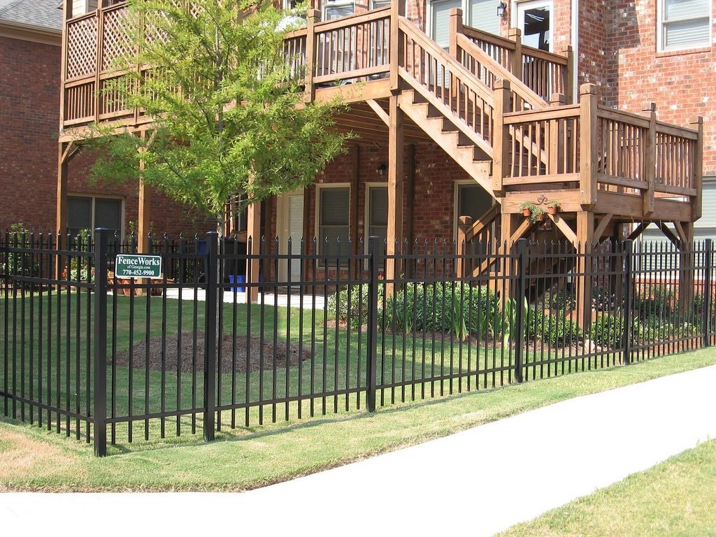 Ornamental metal spear-top fence at a brick home
