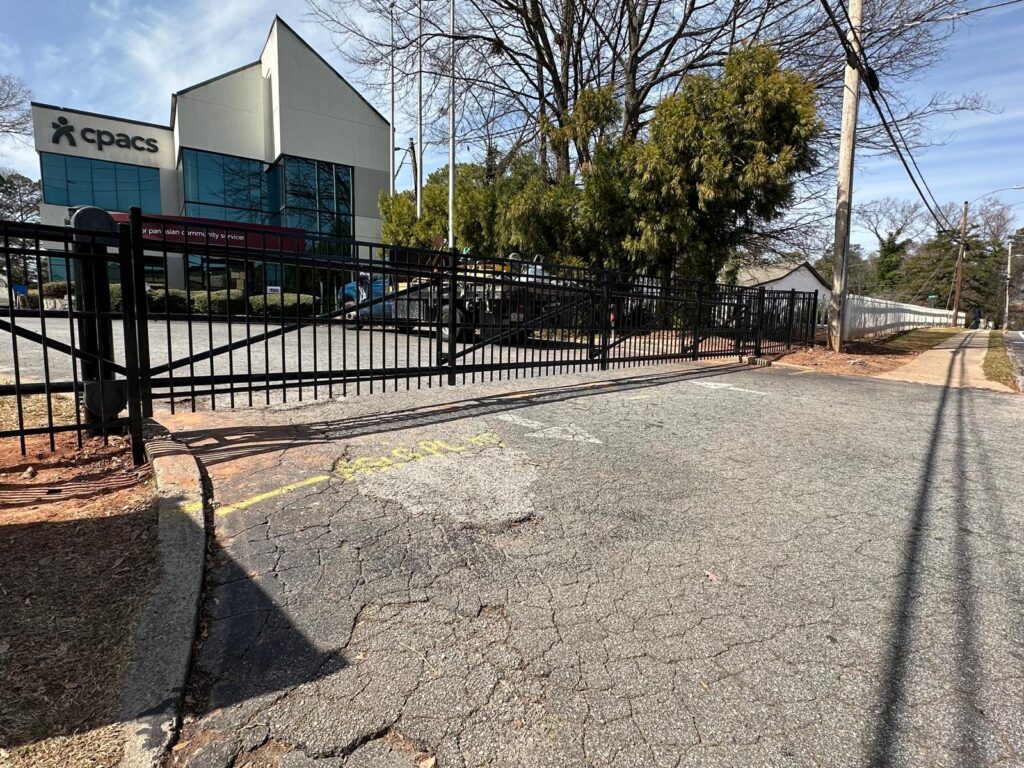 Cantilever slide gate with steel fencing at a commercial lot