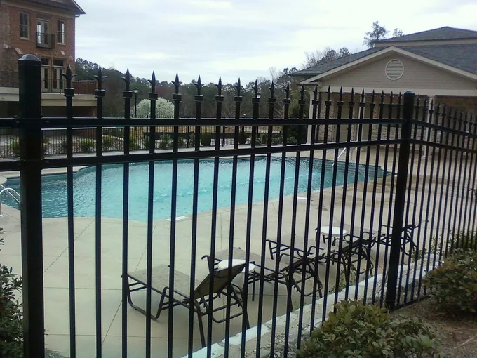 Black ornamental steel fence with a classic wrought-iron look