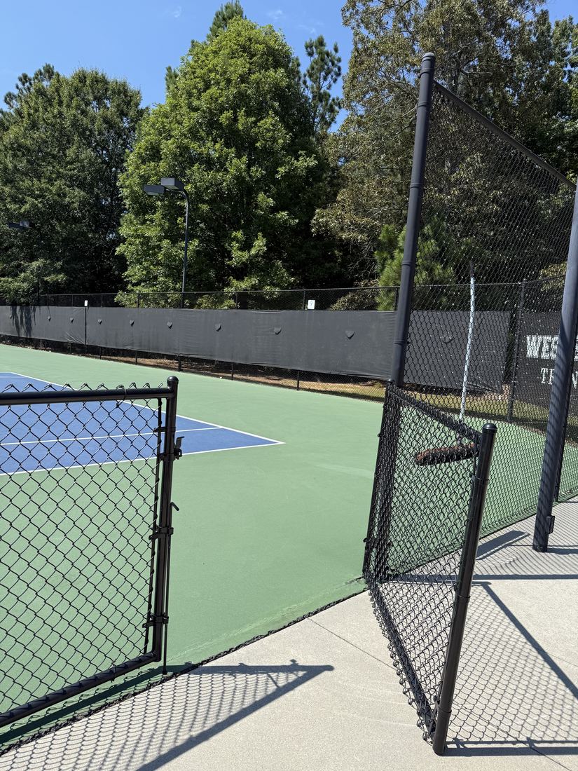 Black vinyl-coated chain link tennis court fence