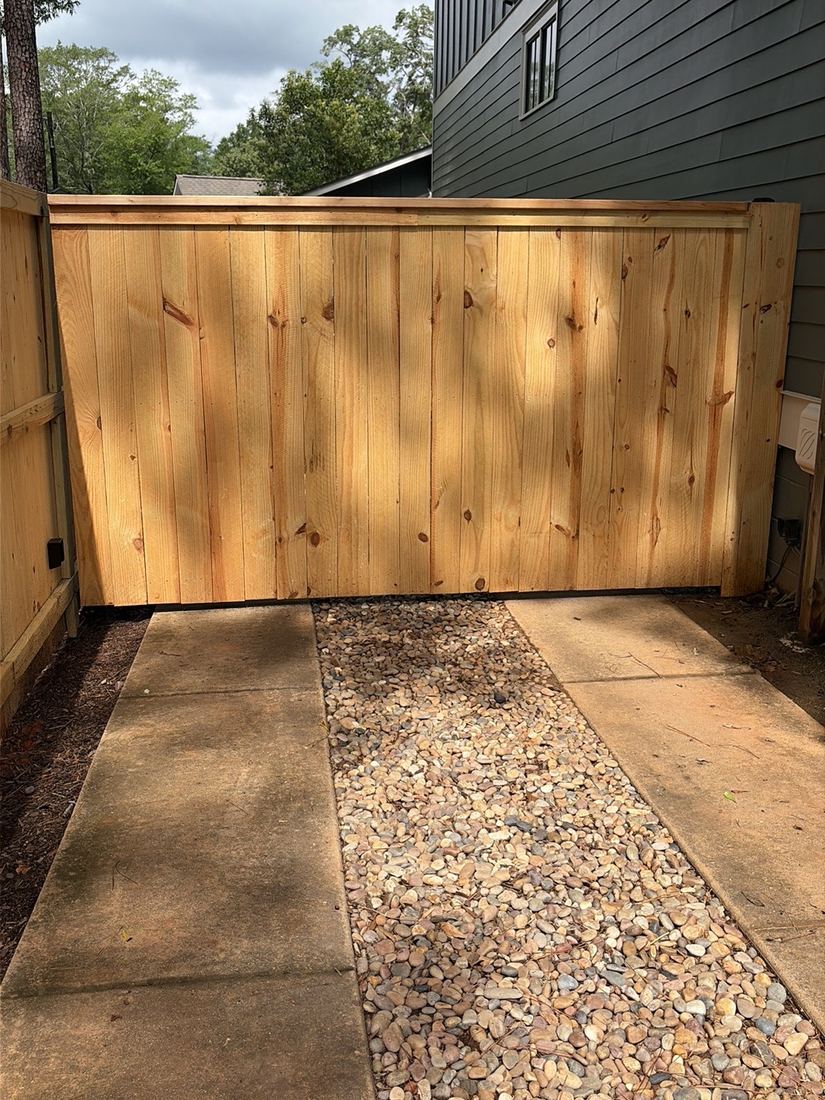 Capped wood privacy automated driveway gate by FenceWorks of Georgia