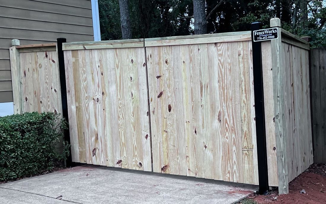 Capped wood privacy driveway gate with 6x6 dado posts