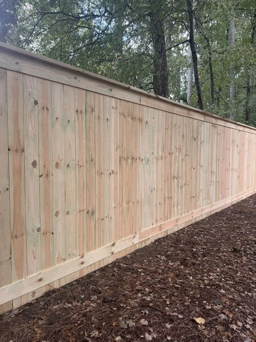 Capped wood privacy fence with kickboard installed in Peachtree Corners, GA