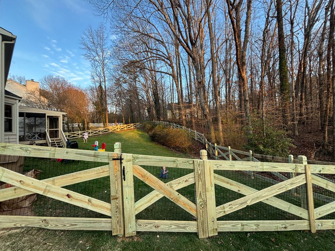 Wood crossbuck ranch rail fence with dado posts and black wire