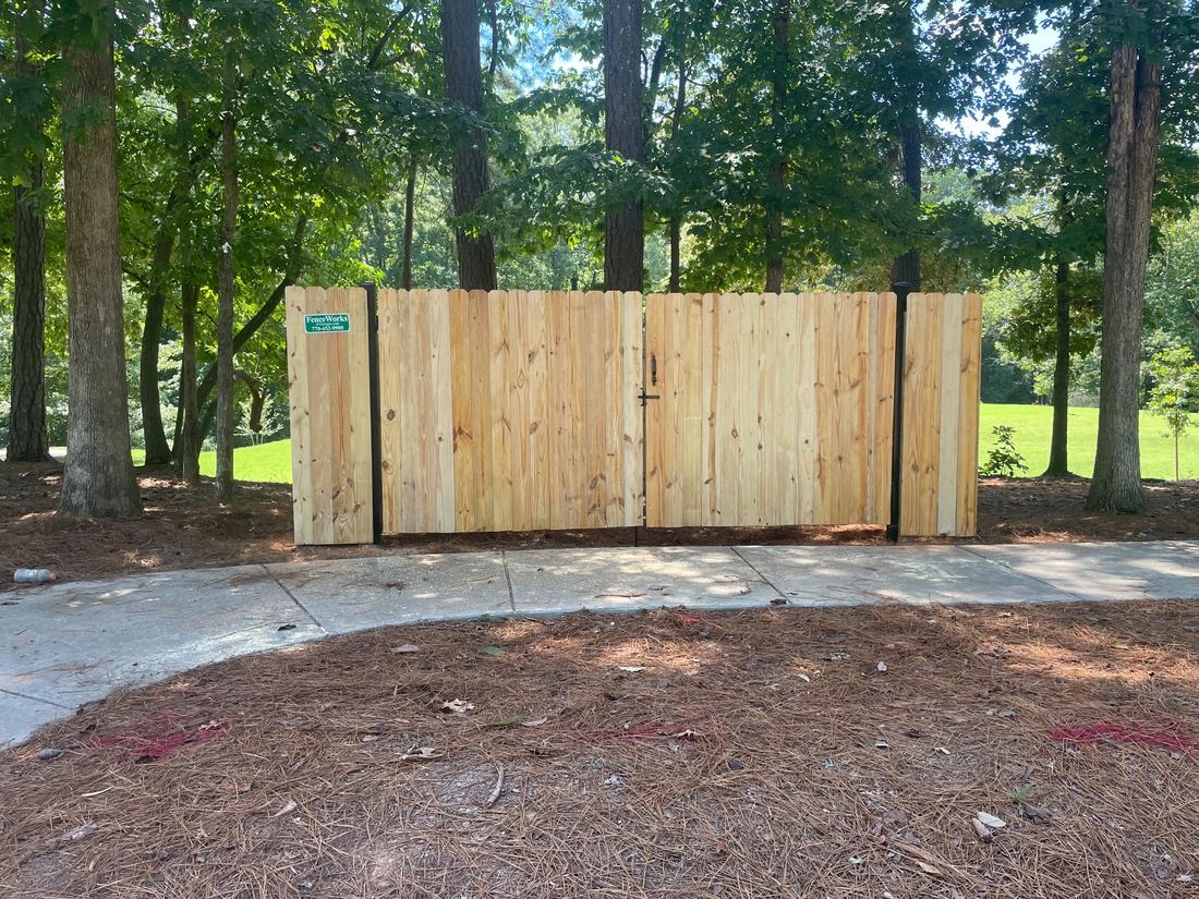 Wood dumpster enclosure with steel frame