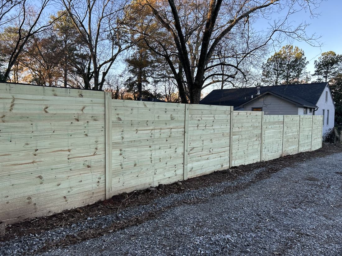Light-toned horizontal wood semi-privacy fence along a Decatur, GA home, built by FenceWorks of Georgia