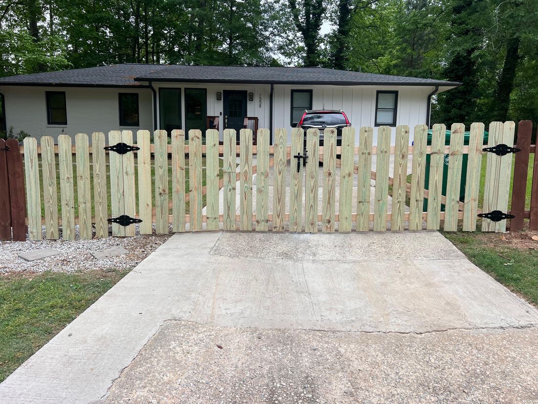 Wood picket fence driveway gate