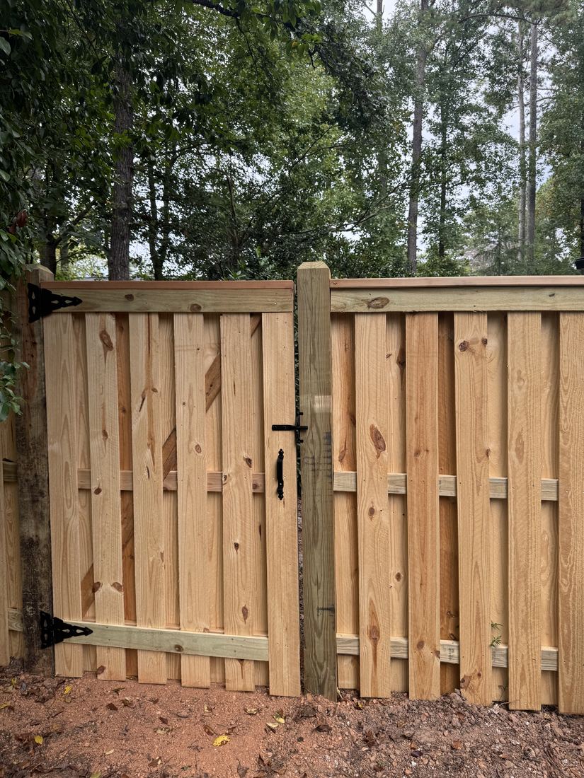 Custom-designed shadowbox wood fence with gate