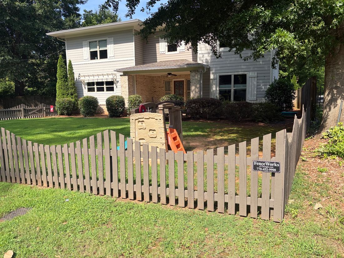 Stained flat picket fence with negative scallop