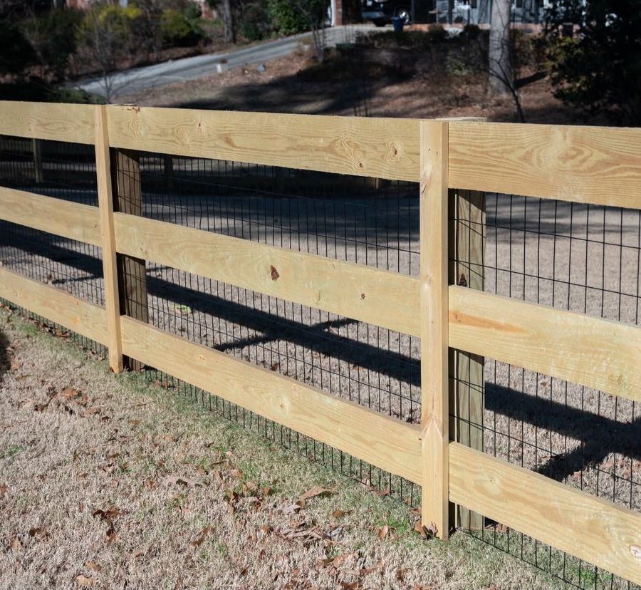 Ranch rail fence with black wire mesh